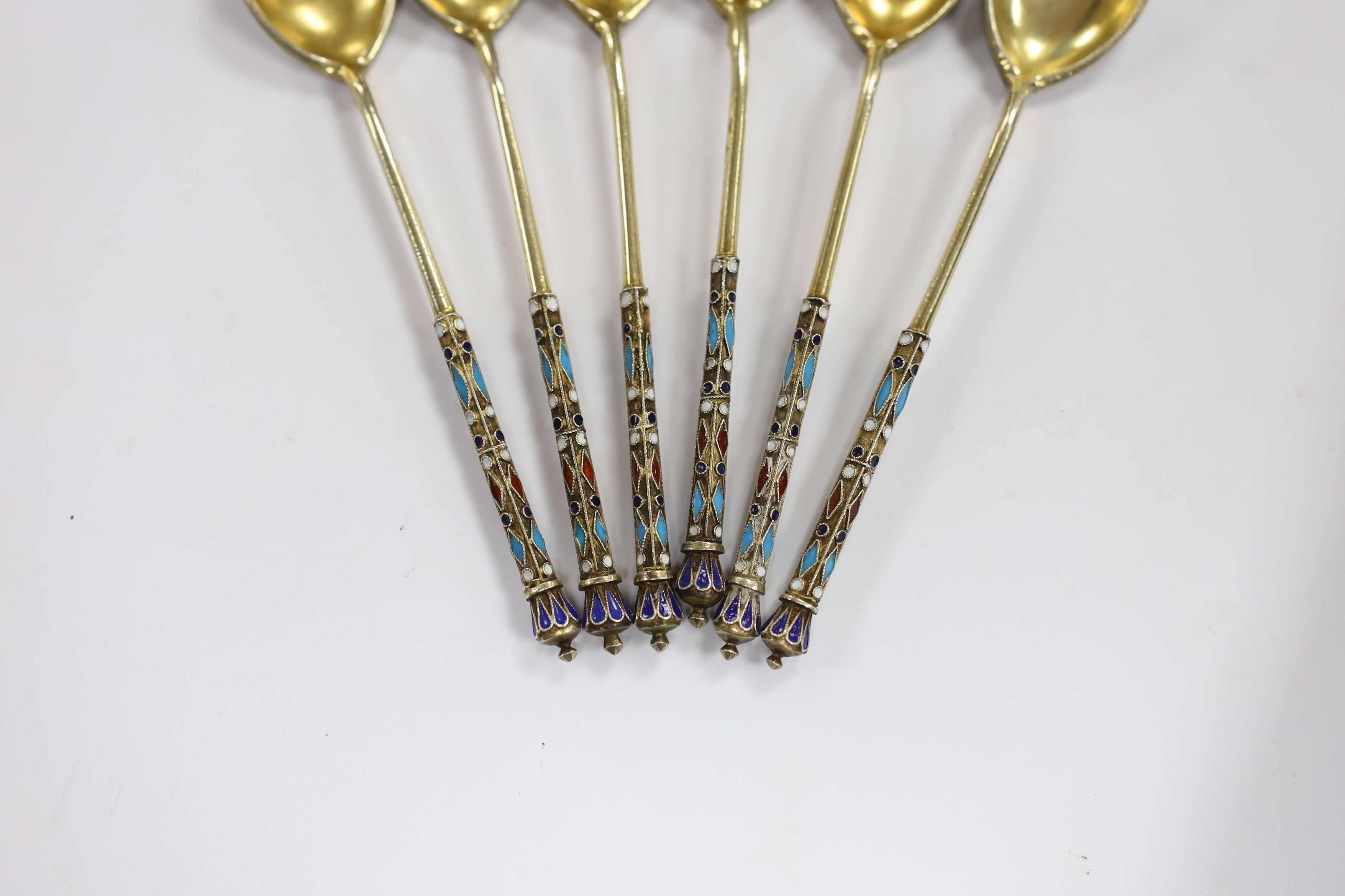 A set of six late 19th century Russian 84 zolotnik gilt white metal and cloisonné enamel coffee spoons, 11.4cm, gross 92 grams.